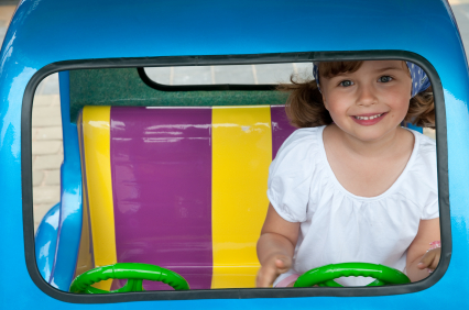 Girl Driving Toy Car